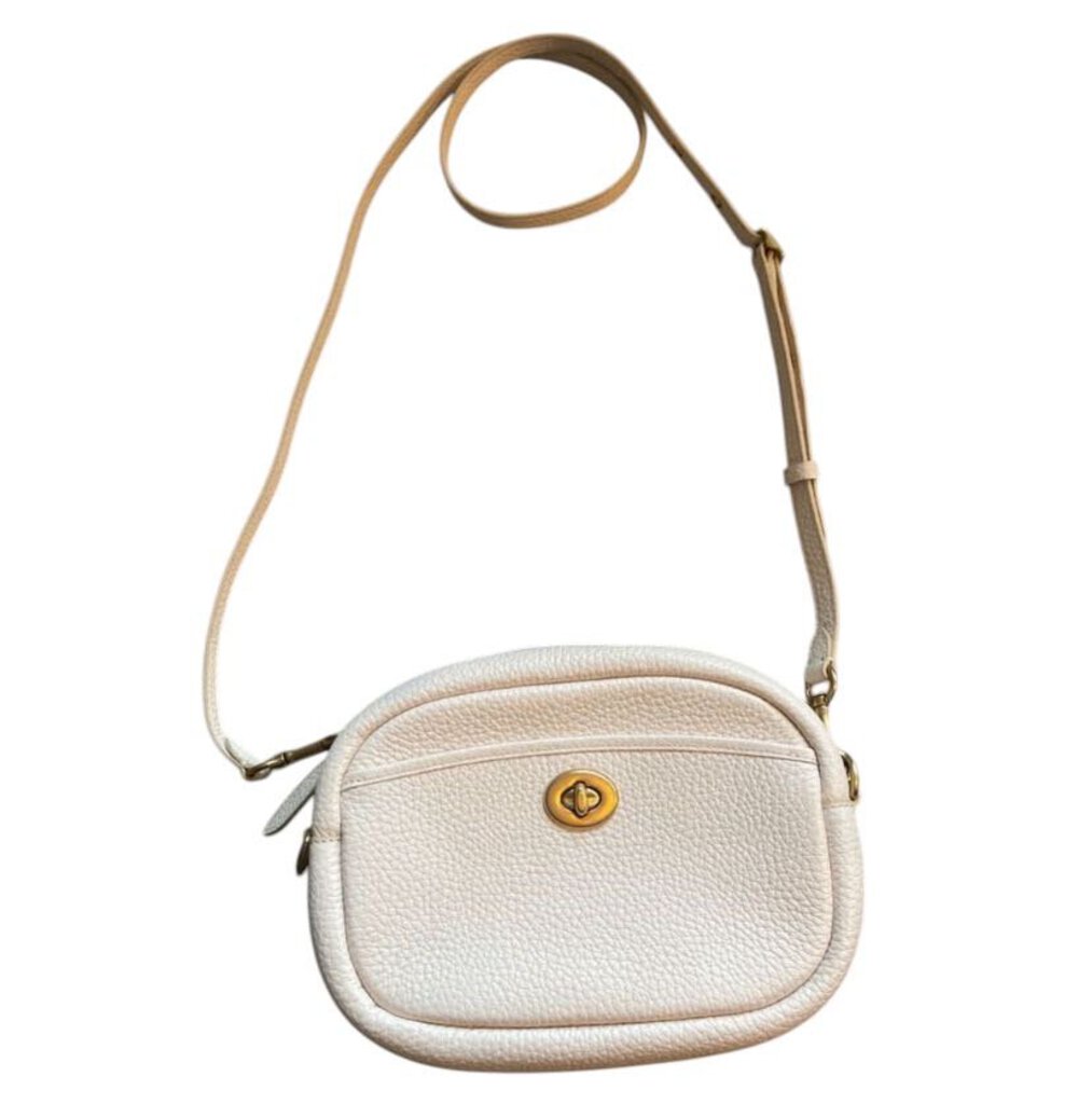 The Coach Pebbled Leather Crossbody Bag offers a timeless, refined design with soft, textured leather and sleek gold-tone hardware. Its compact size and adjustable strap make it a versatile, everyday accessory that effortlessly combines style and functionality.