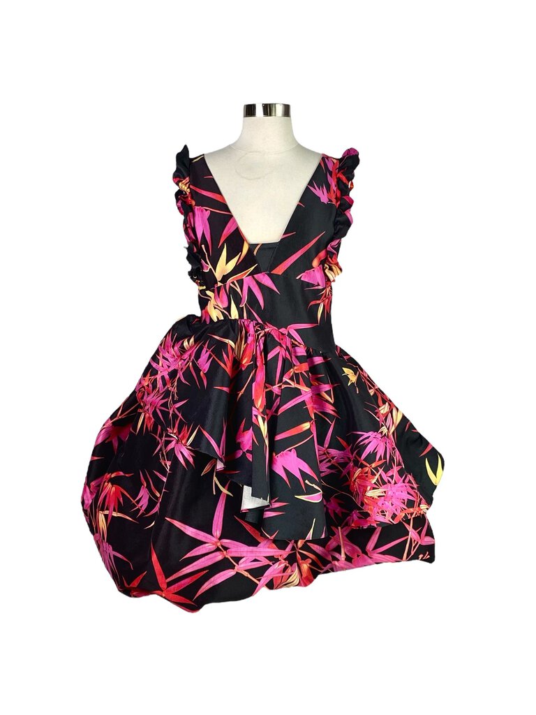 The Kiki Vargas Fuchsia Bamboo 'Lori' Ruffle Dress is a vibrant, eye-catching piece crafted from sustainable bamboo fabric, featuring bold, cascading ruffles that add movement and drama. Its flattering silhouette and striking fuchsia color make it a standout choice for special occasions or evening events.