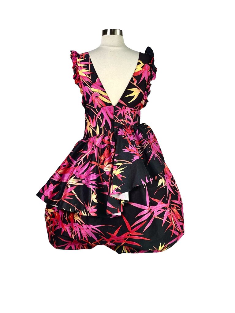 The Kiki Vargas Fuchsia Bamboo 'Lori' Ruffle Dress is a vibrant, eye-catching piece crafted from sustainable bamboo fabric, featuring bold, cascading ruffles that add movement and drama. Its flattering silhouette and striking fuchsia color make it a standout choice for special occasions or evening events.