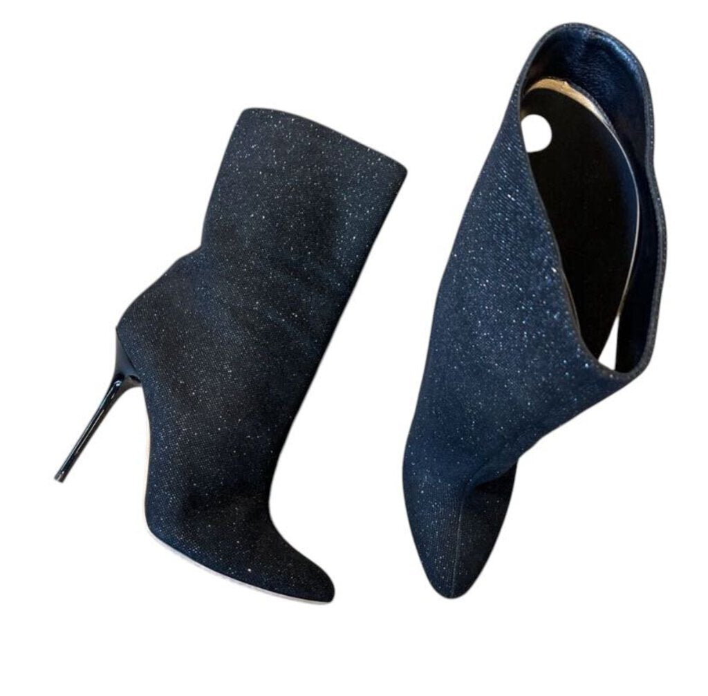 The Jimmy Choo Calf Length Sparkle Booties are a show-stopping blend of glamour and sophistication, crafted from glittering fabric that catches the light with every step. Featuring a sleek, calf-length silhouette and a chic pointed toe, these booties elevate any outfit, making them the perfect statement piece for evening wear or special occasions.