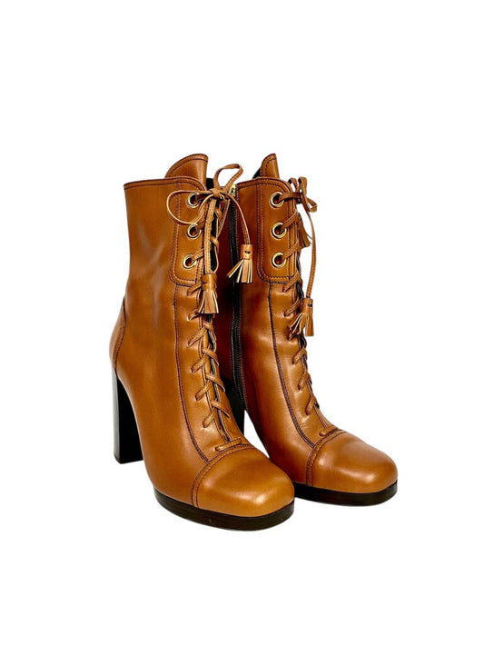 The Miu Miu Platform Lace-Up Block Heel Boots combine bold, contemporary style with a vintage-inspired twist, featuring a chunky platform and block heel for added height and comfort. Crafted from high-quality materials, these boots offer a striking, fashion-forward silhouette that makes a statement while remaining wearable for everyday chic.