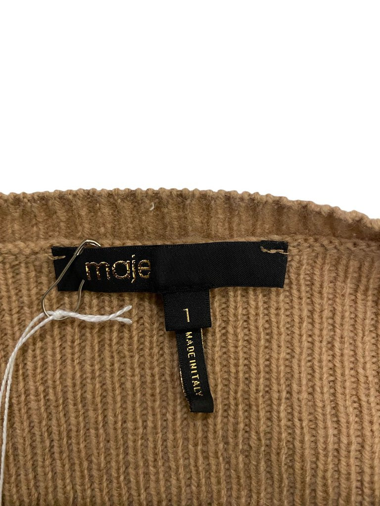 The Maje Ribbed Pleated Shoulder Sweater combines the comfort of a soft knit with stylish pleated detailing at the shoulders, creating a flattering, sculpted silhouette. Its ribbed texture and relaxed fit make it a versatile, elevated wardrobe staple perfect for layering or wearing on its own.