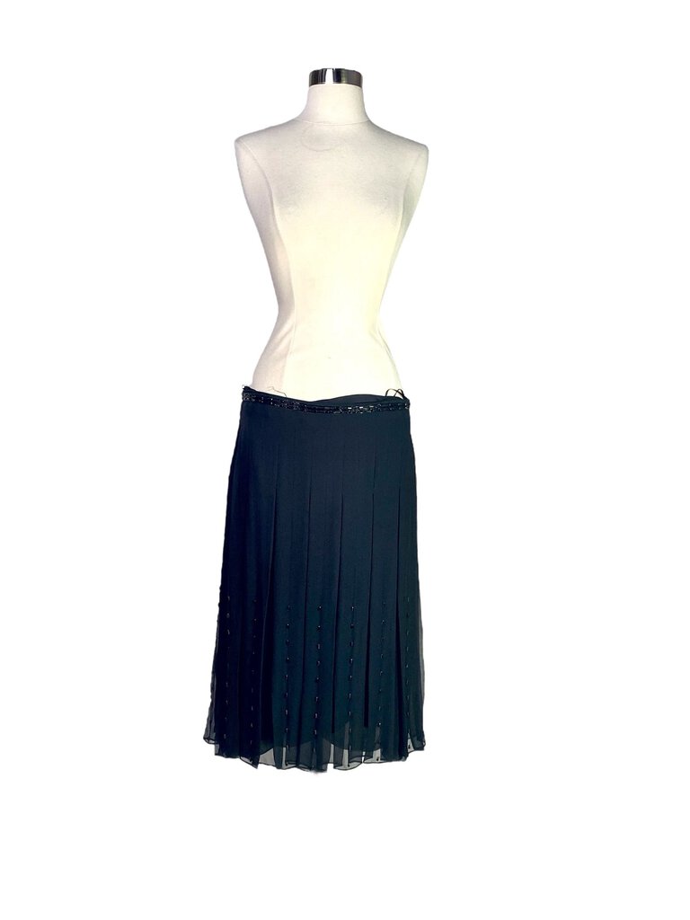 The Chloe Silk Georgette Beaded Midi Skirt features a flowy, ethereal silhouette crafted from luxurious silk georgette, adorned with delicate beading for a touch of glamour. Its midi length and soft drape make it a versatile piece, perfect for elevating both casual and formal looks with understated elegance.