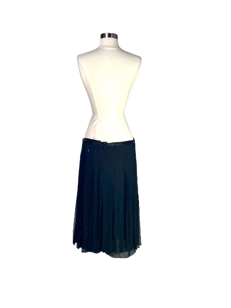 The Chloe Silk Georgette Beaded Midi Skirt features a flowy, ethereal silhouette crafted from luxurious silk georgette, adorned with delicate beading for a touch of glamour. Its midi length and soft drape make it a versatile piece, perfect for elevating both casual and formal looks with understated elegance.