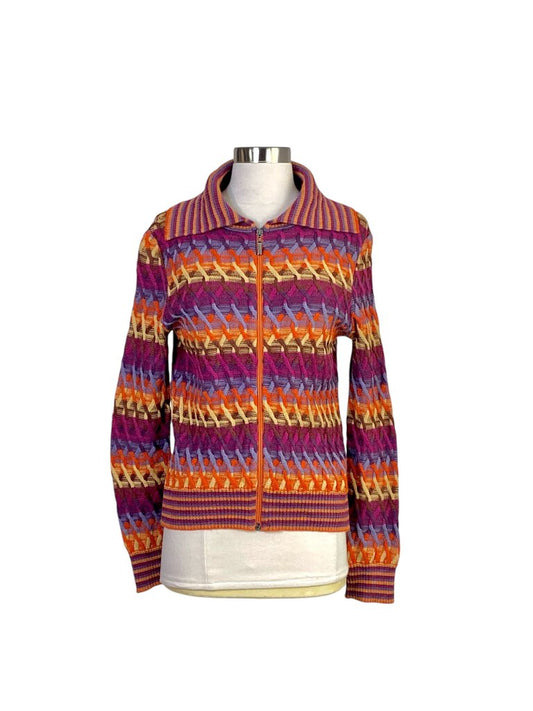 The Missoni Ombre Rainbow Cable Knit Cardigan showcases the brand’s signature vibrant color palette, featuring a striking ombré effect and intricate cable knit design. Its cozy yet chic silhouette makes it a statement piece, perfect for adding a playful and luxurious touch to any outfit.